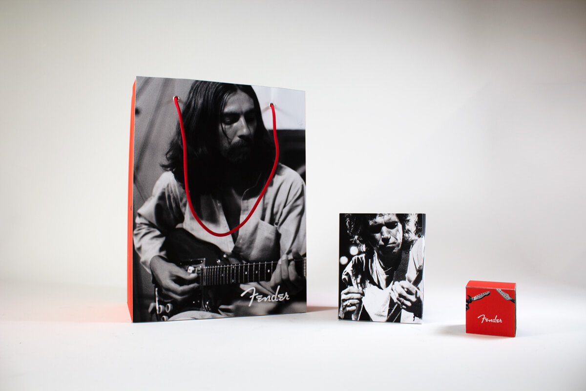 Photo of a bag, a large box, and a small box with Fender branding.