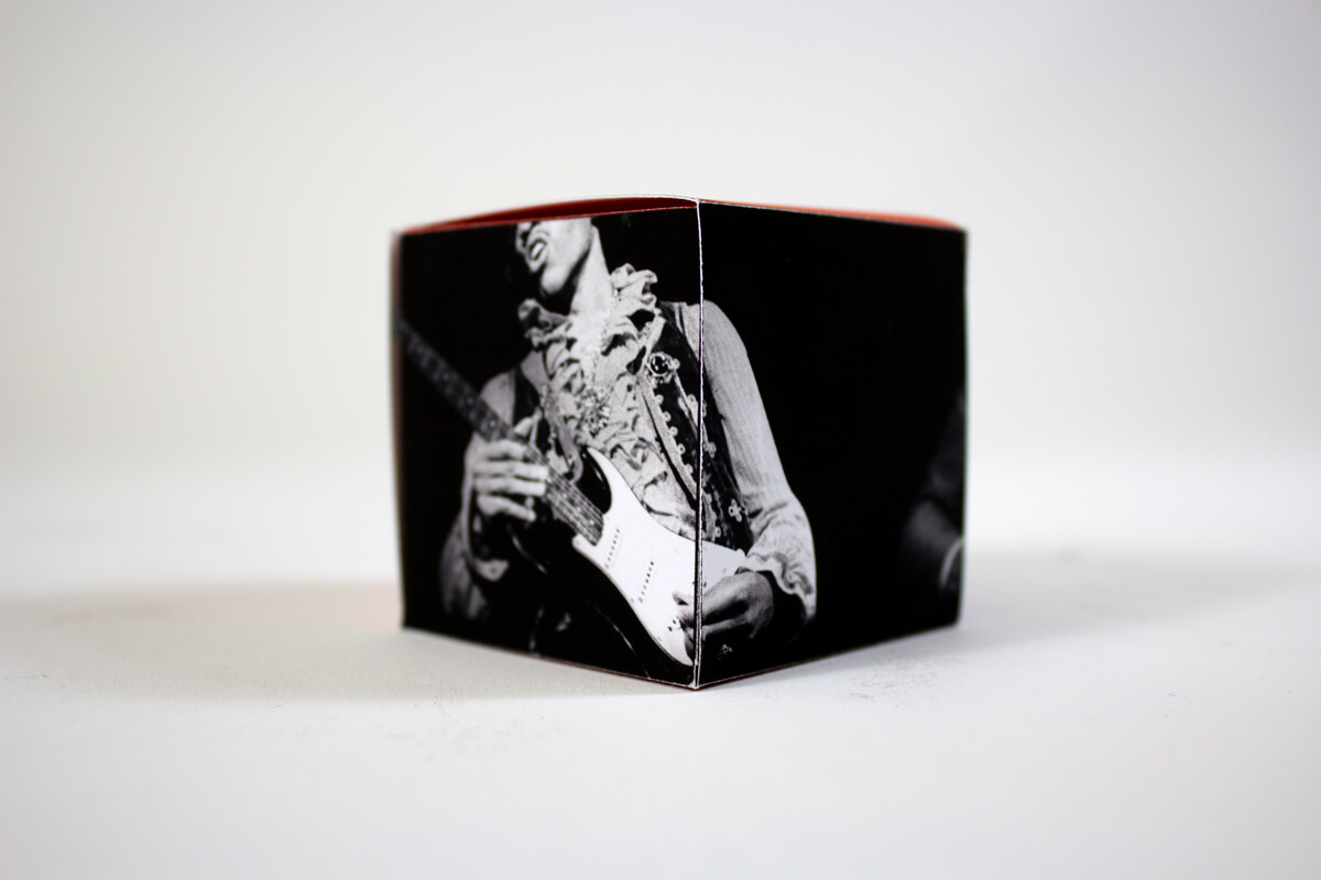 Closeup of a small box with a photo of Jimi Hendrix playing guitar.